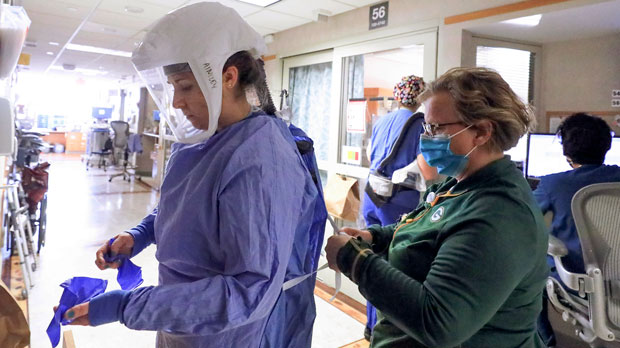 Nurse puts on protective equipment