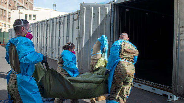 National Guard members assisting with processing COVID-19 deaths, placing them into temporary storage
