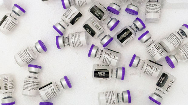 FILE - Vials of the Pfizer-BioNTech COVID-19 vaccine sit in a cooler before being thawed at a pop-up COVID-19 vaccination site in the Bronx borough of New York on Tuesday, Jan. 26, 2021. On Tuesday, Nov. 9, 2021, Pfizer asked U.S. regulators to allow boosters of its COVID-19 vaccine for anyone 18 or older, a step that comes amid concern about increased spread of the coronavirus with holiday travel and gatherings. (AP Photo/Mary Altaffer, File)