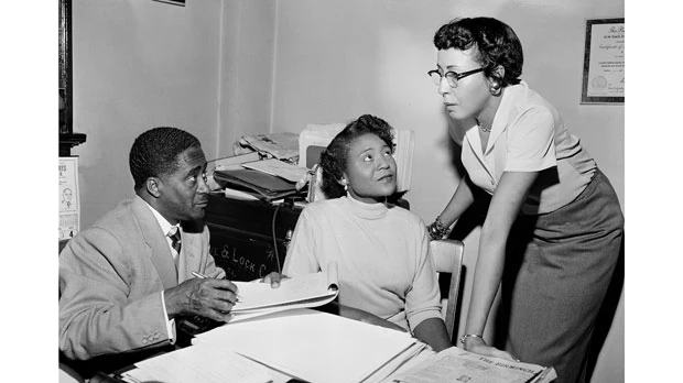 Autherine Lucy Foster, center, the first Black person to attend University of Alabama, discussing her return to campus following mob demonstrations in Birmingham, Ala