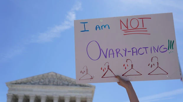 An abortion-rights activists holds a sign reading "I am not Ovary-Acting," during the protests outside of the U.S. Supreme Court, on Tuesday, June 28, 2022, in Washington. (AP Photo/Mariam Zuhaib)