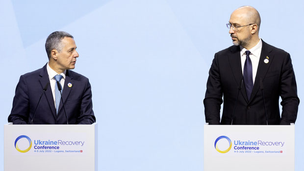 Swiss President Ignazio Cassis, Minister of Foreign Affairs, left, speaks next to Ukrainian Prime Minister Denys Shmyhal during the closing plenary of the Ukraine Recovery Conference URC, Tuesday, on July 5, 2022 in Lugano, Switzerland. The URC is organised to initiate the political process for the recovery of Ukraine after the attack of Russia to its territory. (Michael Buholzer/Keystone via AP)