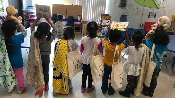 Children receive “Night Night” tote bags. Photo Courtesy of: Project Night Night.