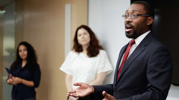 "Policy and Advocacy Manager speaks during the United States Conference on Aids" Photo Courtesy of: National Minority AIDS Council