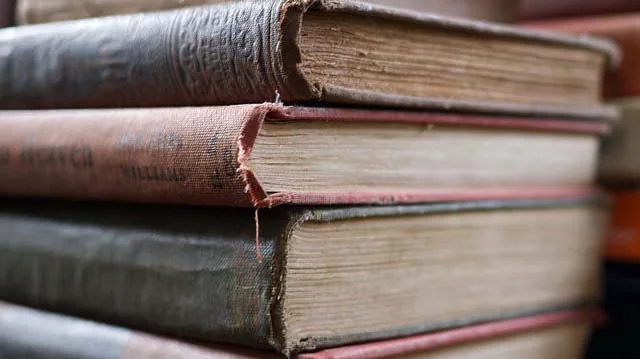 "Stack of Old Books" by Austin Kirk licensed under CC BY 2.0