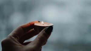Hand holding candle