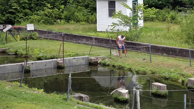 A worker repairs fencing