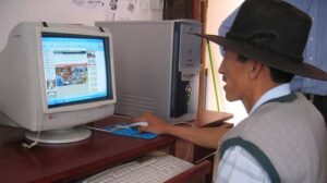 "M&E pic man behind computer" by IICD licensed under CC BY 2.0