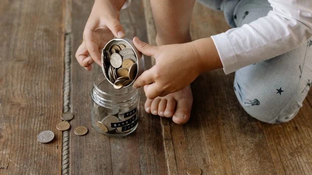 Photo by cottonbro: https://www.pexels.com/photo/a-person-putting-the-coins-inside-the-glass-jar-7118214/