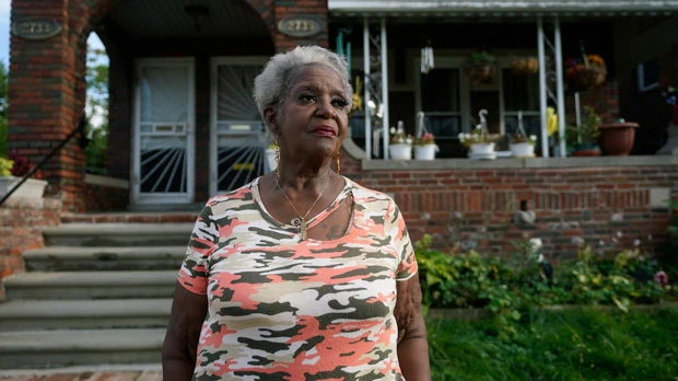 Pamela Jackson-Walters stands outside her home