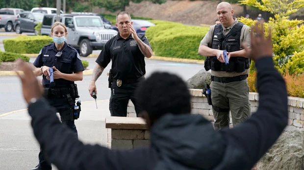 Ken Westphal, center, an officer with the Lacey Police Dept.