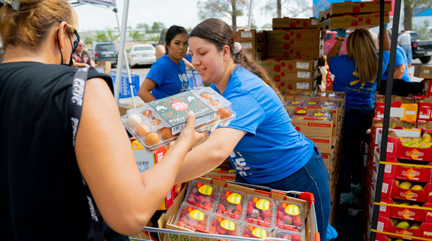 El Pasoans Fighting Hunger volunteers distribute food at a center in El Paso, Texas