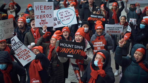 Nurses shout slogans during a nursing strike outside Mount Sinai Hospital
