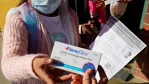 FILE - A second grade student is given a at-home COVID-19 test at H.W. Harkness Elementary School in Sacramento, Calif., on Feb. 11, 2022. The declaration of a COVID-19 public health emergency three years ago changed the lives of millions of Americans by offering increased health care coverage, beefed up food assistance and universal access to coronavirus vaccines and tests. Much of that is now coming to an end, with President Joe Biden's administration saying it plans to end the emergencies declared around the pandemic on May 11, 2023. (AP Photo/Rich Pedroncelli, File)