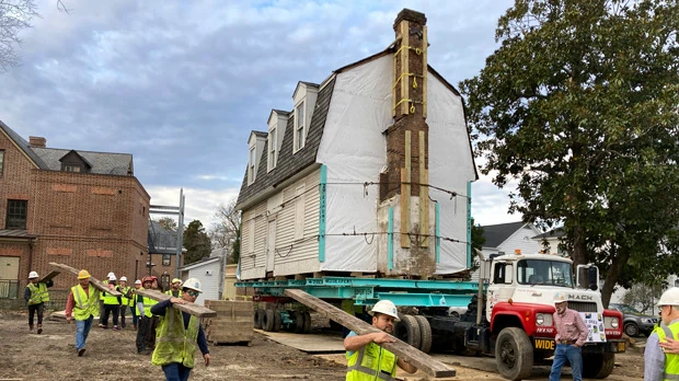 Workers prepare to move the original structure that held what is believed to be the oldest schoolhouse in the U.S. for Black children in Williamsburg, Virginia, on Friday, Feb. 10, 2023. (AP Photo/ Ben Finley)